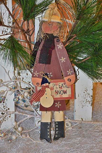 Winter Girl mit Mütze und Schild "Please Snow"